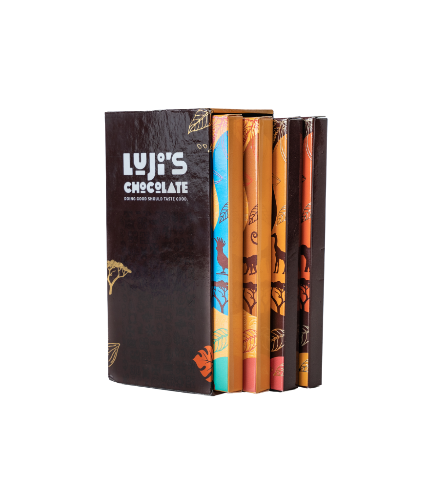 side view of Luji's Chocolate bars lined up inside the library collection set, highlighting the colorful spine of each flavor's packaging with distinctive African motifs.